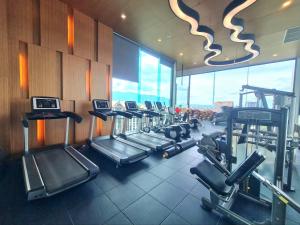 a gym with a row of treadmills and machines at 2 Bedroom apartment near Chiang mai Night Bazzar in Chiang Mai