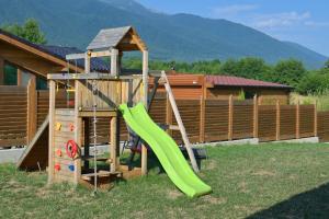 a playground with a green slide and a play structure at Villa Raphael near the Bansko Ski Resort in Razlog