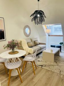 a living room with a couch and a table and chairs at Gonzalez del Valle in Oviedo