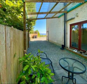 a patio with a table and a fence at Yellow door cottage in Moville