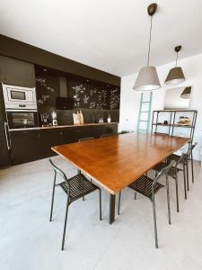 a dining room with a wooden table and chairs at Villa Koa - Riders Surf n Bike in El Roque
