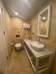 a bathroom with a sink and a toilet at Life Butiq Otel in Yalıkavak