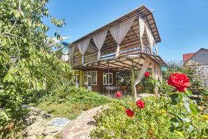 a house with roses in front of it at Green guest house in Chornomorsk