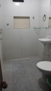 a white bathroom with a sink and a toilet at Xareu-Balanço das Ondas! in Cabo de Santo Agostinho