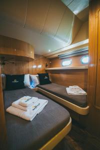 two beds in a boat with towels on them at DiscoverBoat - Pita - Exclusive Boat&Breakfast in Bari