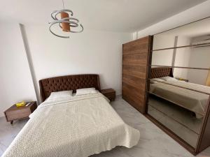 a bedroom with a large bed and a mirror at شقة فندقية جديدة في مدينتي in Cairo