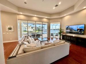 a large living room with a couch and a table at Luxury Rental Walkable To Beach With Wide Water Views I Pet Friendly in Henry Key +33 photos