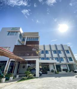 a building with a car parked in a parking lot at JRP Vanyard Resort Hotel in Kalibo