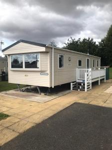 a tiny house is parked on a lot at 48 Oak Village Grange Leisure Park in Mablethorpe