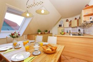 a kitchen with a wooden table with food on it at Weidenweg 4d in Ostseebad Karlshagen
