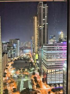 a view of a city at night with buildings at Avant Apartments at The Fort in Manila