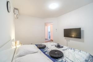 a bedroom with a bed with two hats on it at Beautiful apartment Lena in Split
