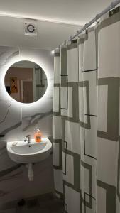 a bathroom with a sink and a mirror at Beautiful apartment Lena in Split +9 photos