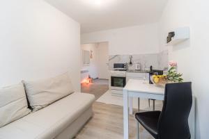 a living room with a white couch and a table at Beautiful apartment Lena in Split