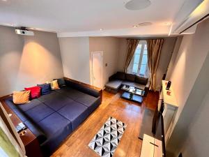 an overhead view of a living room with a couch at 4 floor Apartment in Covent Garden in London