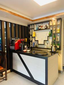a kitchen with a counter with a red appliance at Hotel Abi International in Kathmandu