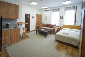 a living room with a bed and a couch at PRENOCISTE SOLE in Vranje