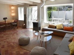 a living room with a couch and a stove at Maison Les Portes-en-Ré, 4 pièces, 6 personnes - FR-1-434-17 in Les Portes