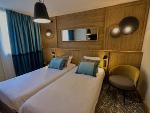 Hôtel L'Eden des Cimes - Vacances Bleues - Belle Plagne 2100にあるベッド