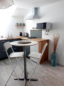 kuchnia ze stołem i krzesłami w kuchni w obiekcie Studio Le Refuge w mieście Champ-sur-Drac