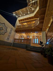 a large room with a large wooden floor in a building at Hanifa Boutique Hotel in Samarkand