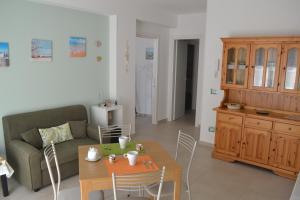 a living room with a couch and a table at Casa Ventitré in Balestrate