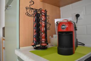 a kitchen counter with a red appliance on a counter top at Casa Ventitré in Balestrate +24 photos