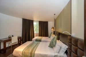 Кровать или кровати в номере Ambara Suites