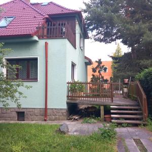 a house with a wooden deck in front of it at Apartment in the city of Pilsen in Božkov