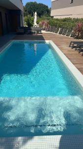 a large blue swimming pool next to a house at Apartment in the city of Pilsen in Božkov