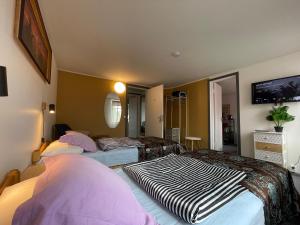 a hotel room with two beds and a tv at Westhouse in Haapsalu