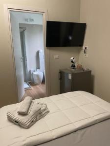 a bedroom with a bed with a towel on it at Cucchiari Suite 8A in Modena