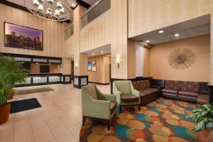 a lobby with a waiting room with a couch and chairs at Days Inn by Wyndham Baltimore Inner Harbor in Baltimore