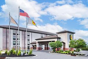 an image of a hotel with flags in front of it at Super 8 by Wyndham Mount Laurel in Mount Laurel