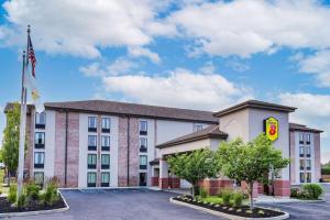 a hotel with a flag in a parking lot at Super 8 by Wyndham Mount Laurel in Mount Laurel