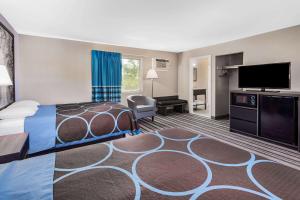 a hotel room with a bed and a flat screen tv at Super 8 by Wyndham Marysville/Port Huron Area in Marysville