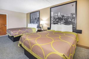 a hotel room with two beds in a room at Super 8 by Wyndham Mount Laurel in Mount Laurel