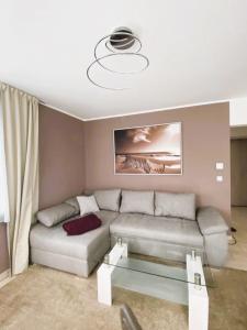 a living room with a couch and a chandelier at Fewo II Familie Sobierajczyk in Blankenhagen