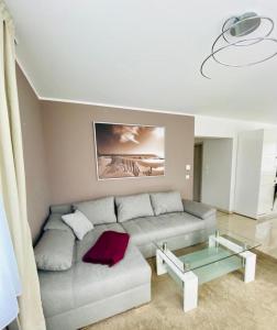 a living room with a couch and a glass table at Fewo II Familie Sobierajczyk in Blankenhagen