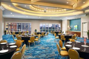 a conference room with tables and chairs and windows at Homewood Suites Atlanta Midtown in Atlanta