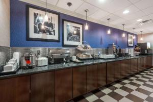 a buffet line in a restaurant with a counter at Wingate by Wyndham Springfield in Springfield