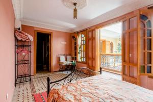 a bedroom with a bed and a balcony at Riad Dar Saidi in Rabat