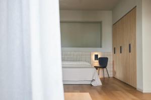 A bed or beds in a room at Mima Aparthotel Boutique & Spa