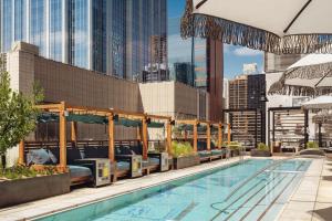 a swimming pool with a view of a city at Thompson Austin, by Hyatt in Austin