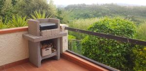 a outdoor fireplace on a balcony of a house at Anna's House in Lorenzana
