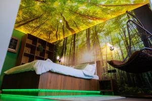 a bedroom with a swinging bed in a forest mural at Relaxveld Nature in Curtea de Argeş