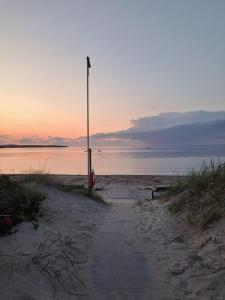 a street light on the beach at sunset at Harmony in Farhult in Farhult
