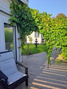 a bench sitting on the porch of a house at Harmony in Farhult in Farhult