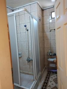 a shower with a glass door in a bathroom at hilal in Erzurum