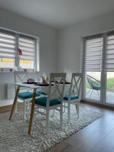 a dining room with a table and two chairs at Apartment Una in Kupres